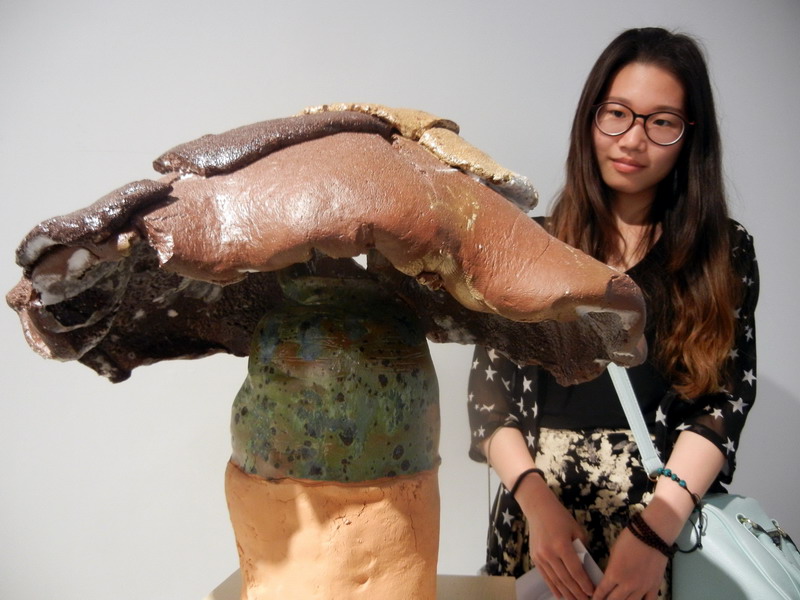 Une visiteuse admire une ?uvre en céramique de l'artiste norvégien Steinar Haga Kristensen intitulée ? Le désespoir dans l'Argile-II ?, au Musée d'Art du Lac Jinji de Suzhou, le 24 mai 2014. [Photo Wang Jiankang / asianewsphoto.com]