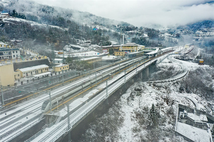 Hubei : des trains transportent des passagers le long des monts Wuling enveloppés de neige