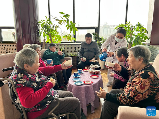 Des personnes agées souffrant de troubles cognitifs prennent un café au centre de remédiation cognitive Hetong situé à Tianjin dans le nord de la Chine. (Photo/Xinhua)