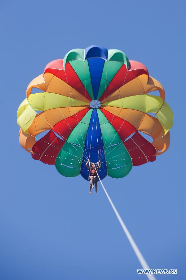 Des touristes en parachute ascensionnel sur la plage Baga à Goa, dans le sud-ouest de l'Inde, le 22 novembre 2013. La haute saison touristique a commencé à Goa en novembre. Des plages et un climat doux en hiver font de Goa un des meilleures destinations touristiques dans le sud de l'Inde, attirant des touristes nationaux et internationaux. 